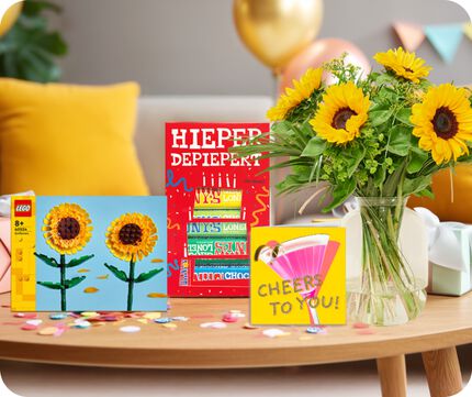 Verschillende verjaardagscadeaus waaronder LEGO, chocolade en bloemen